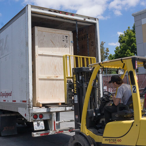 Larson Packaging team member loading crates on a truck, ready for delivery to customer