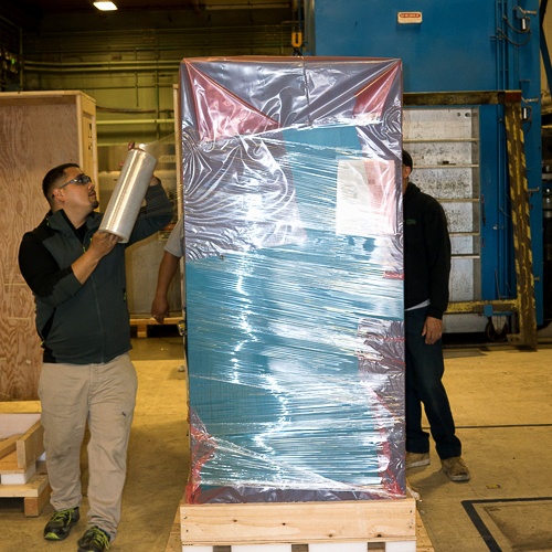 Rack crate being plastic wrapped 