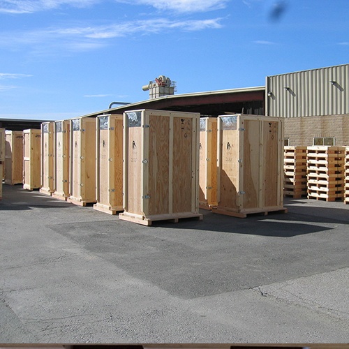 Custom built industrial wooden rack crates built by Larson Packaging Company sitting in yard ready for transport