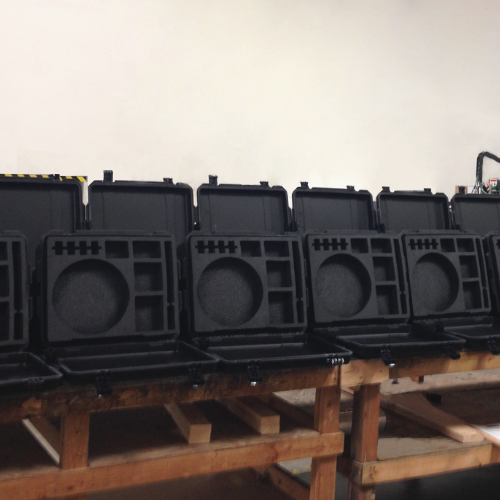 Black molded cases with custom foam inserts designed and manufactured by Larson Packaging Company