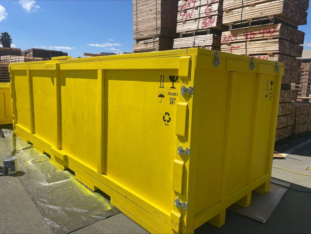 wooden shipping crate painted yellow
