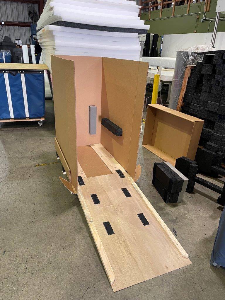 hybrid wood and corrugated box with custom ramp to load heavy equipment